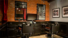 interior of barbershop with chairs and a mirror